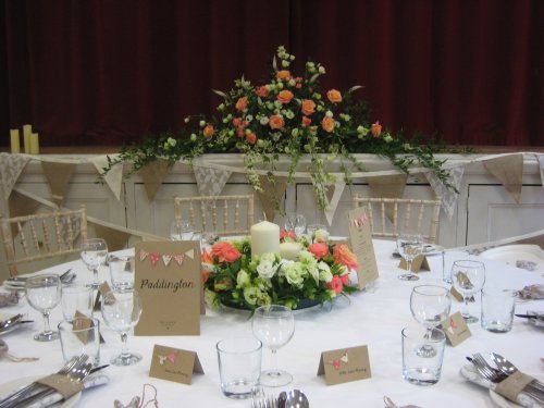 (58) Flowers look wonderful against the maroon velvet stage curtain. image